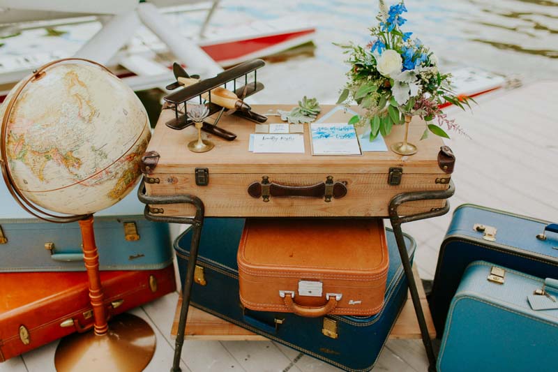 suite case table with blue watercolor invitation suite on top