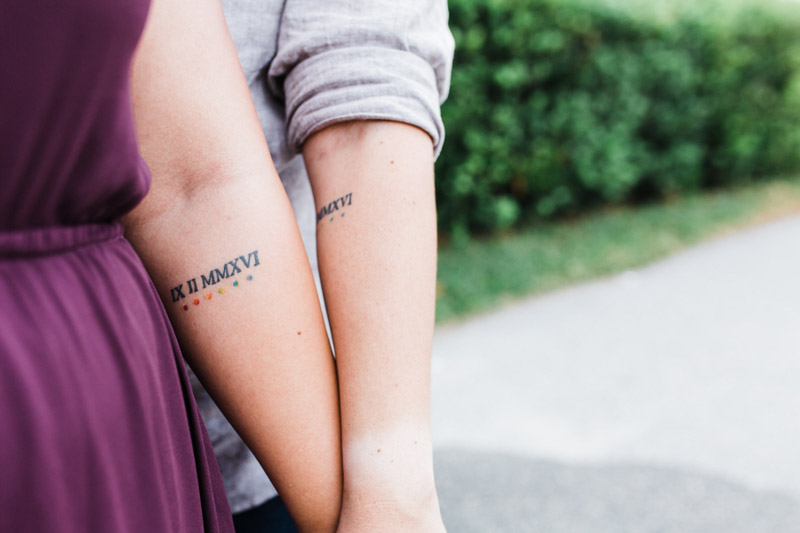 couple with matching dates tattooed on their arm