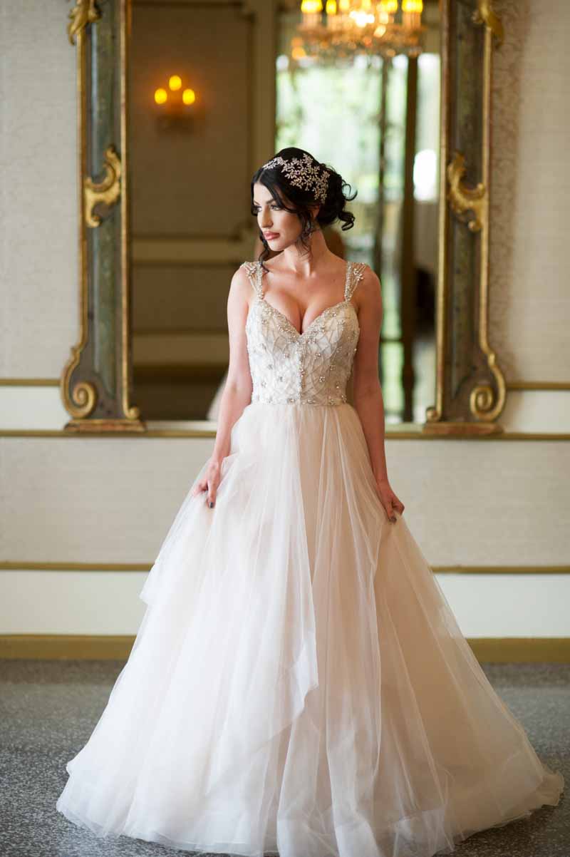 bride standing in front of mirror in wedding gown
