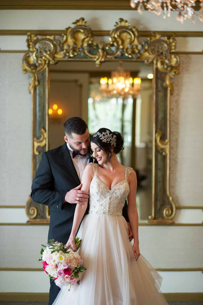 groom hold bride holding bridal bouquet