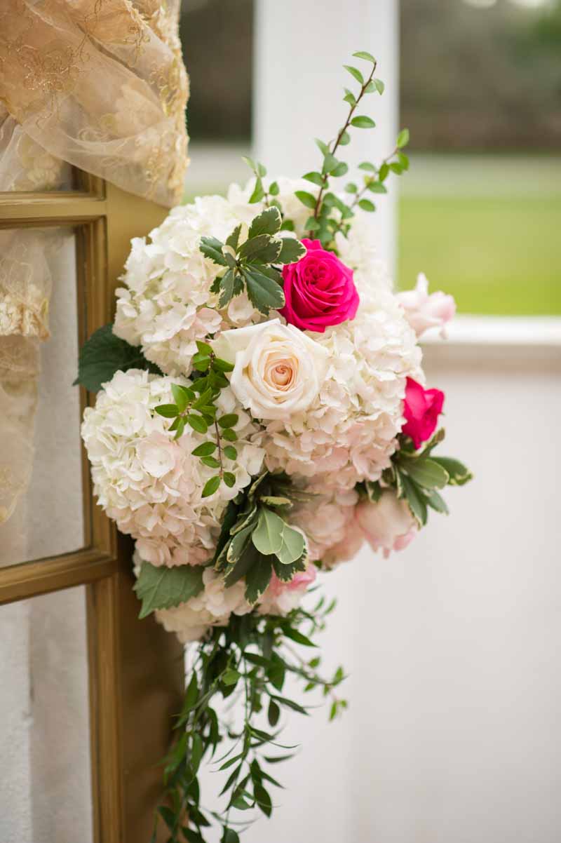 wedding floral ceremony arrangement hanging on door