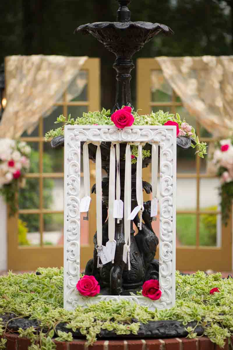 escort cards hanging from frame with key