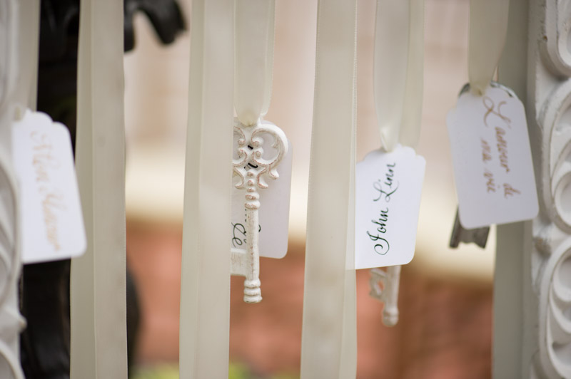 white vintage key hanging from escort card