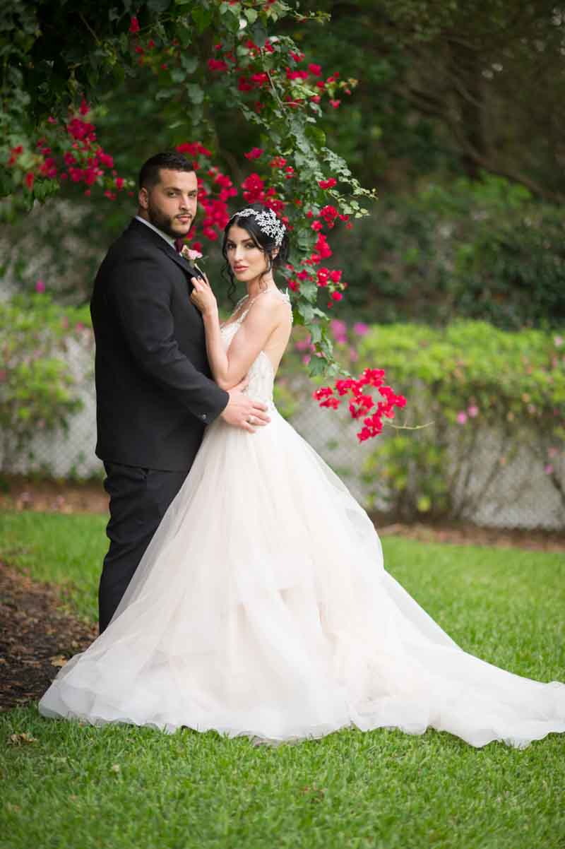 bride and groom under tree in garden