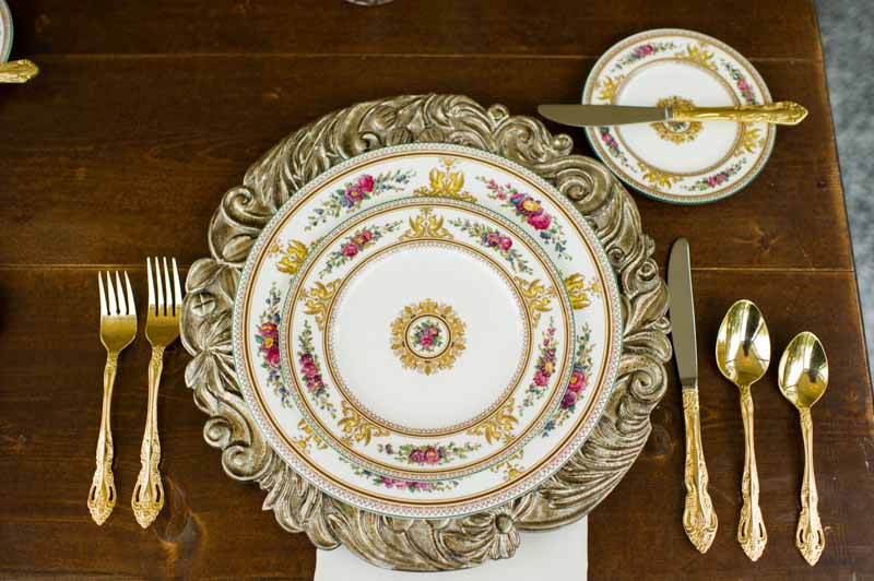 fine china with floral detail and gold flatware