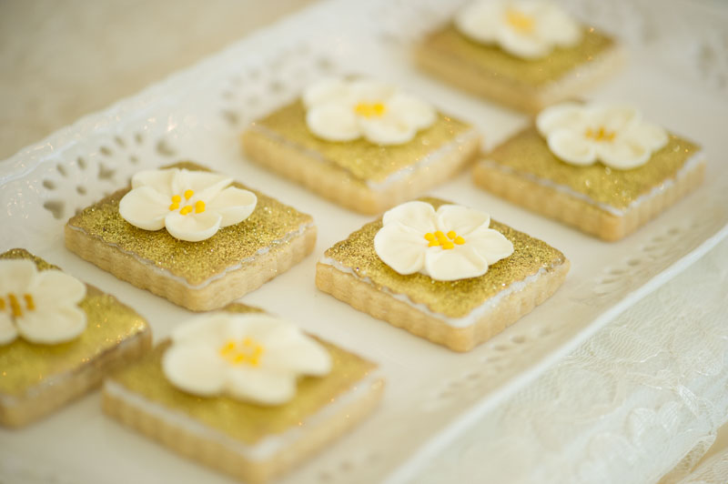 cookies with edible gold glitter and white flower