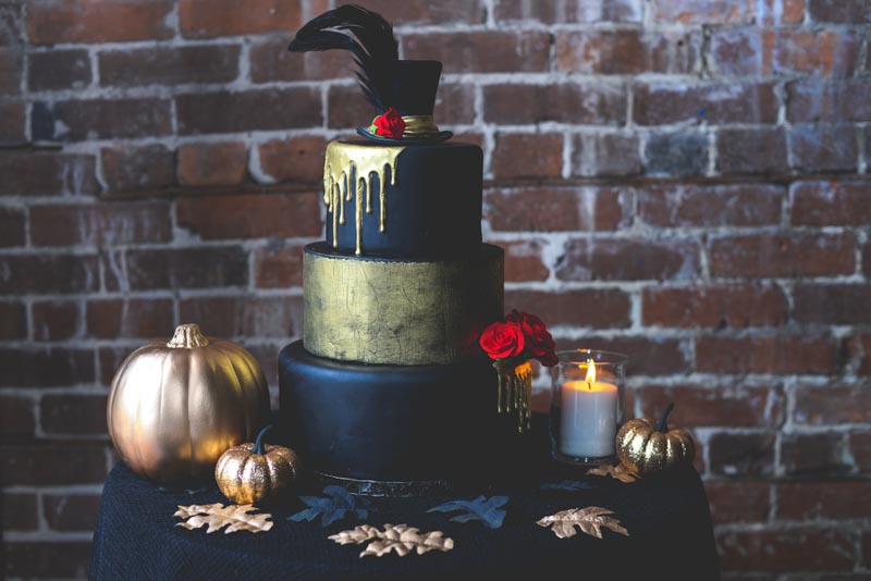 black and gold wedding cake with gold drizzle