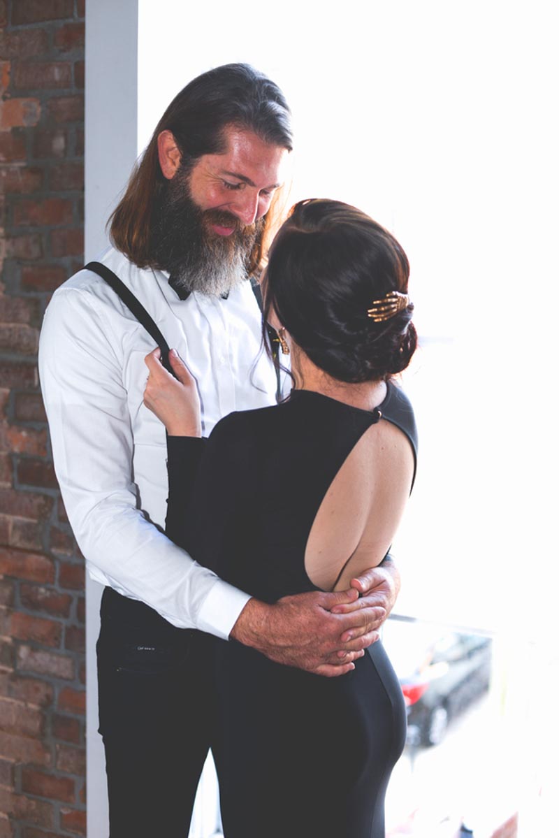 groom smiling looking down at bride for Halloween inspired wedding