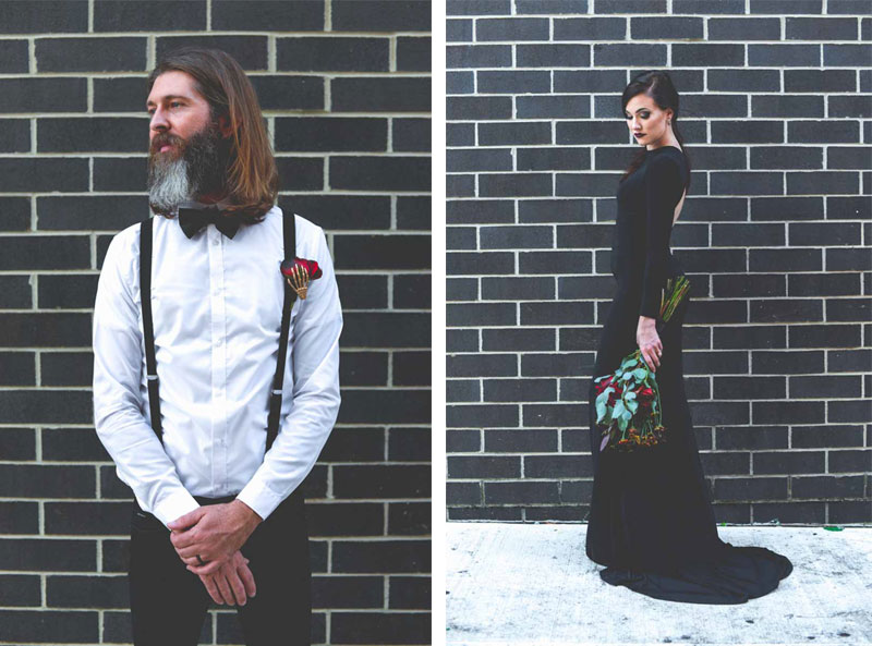 bride and groom standing in front of black brick wall