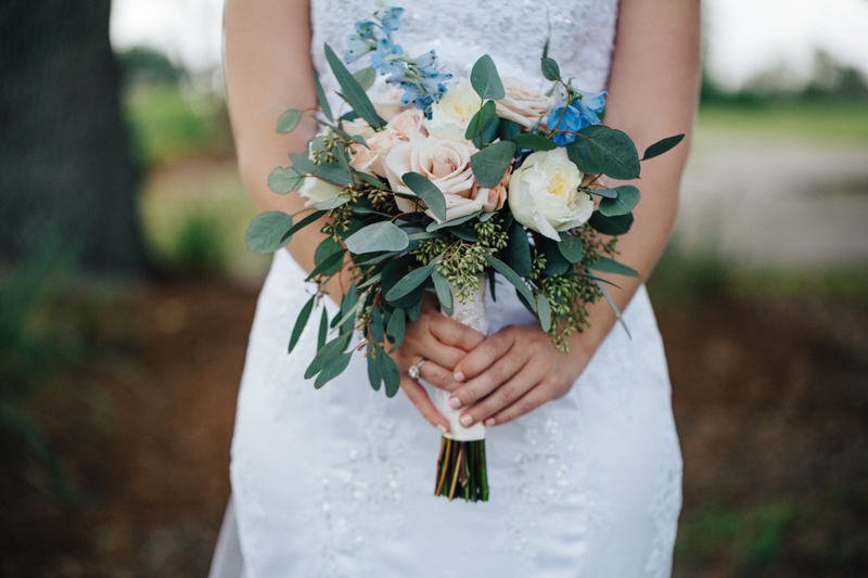 bride holding blush and white rose bouquet