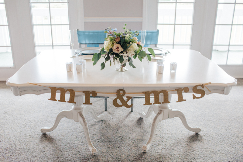mr. and mrs. sign on sweetheart table