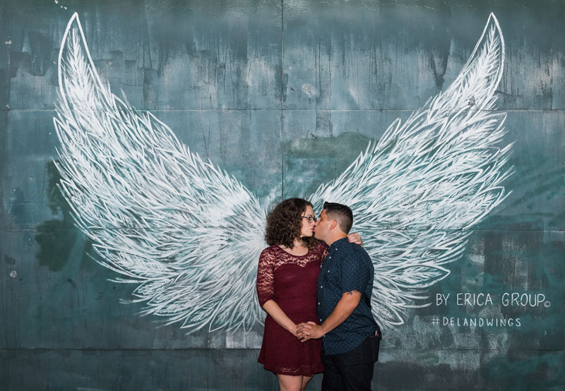 couple kissing in front of Deland Wings