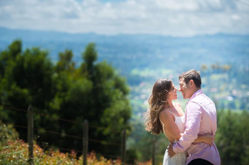 couple at engagement session on a hill