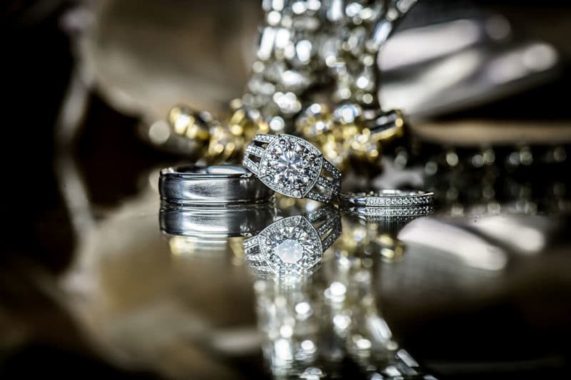 wedding rings on table for questions for your wedding photographer article