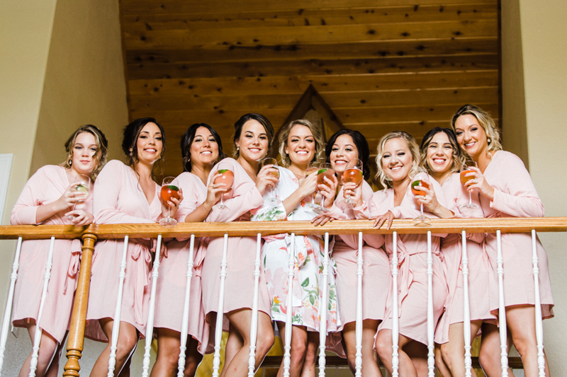 bride and bridesmaids looking over balcony