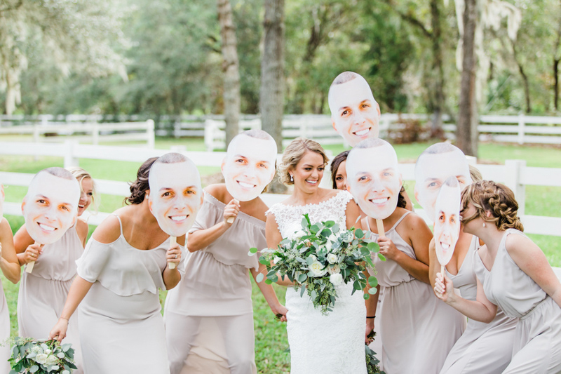 bridesmaids holding faces of groom