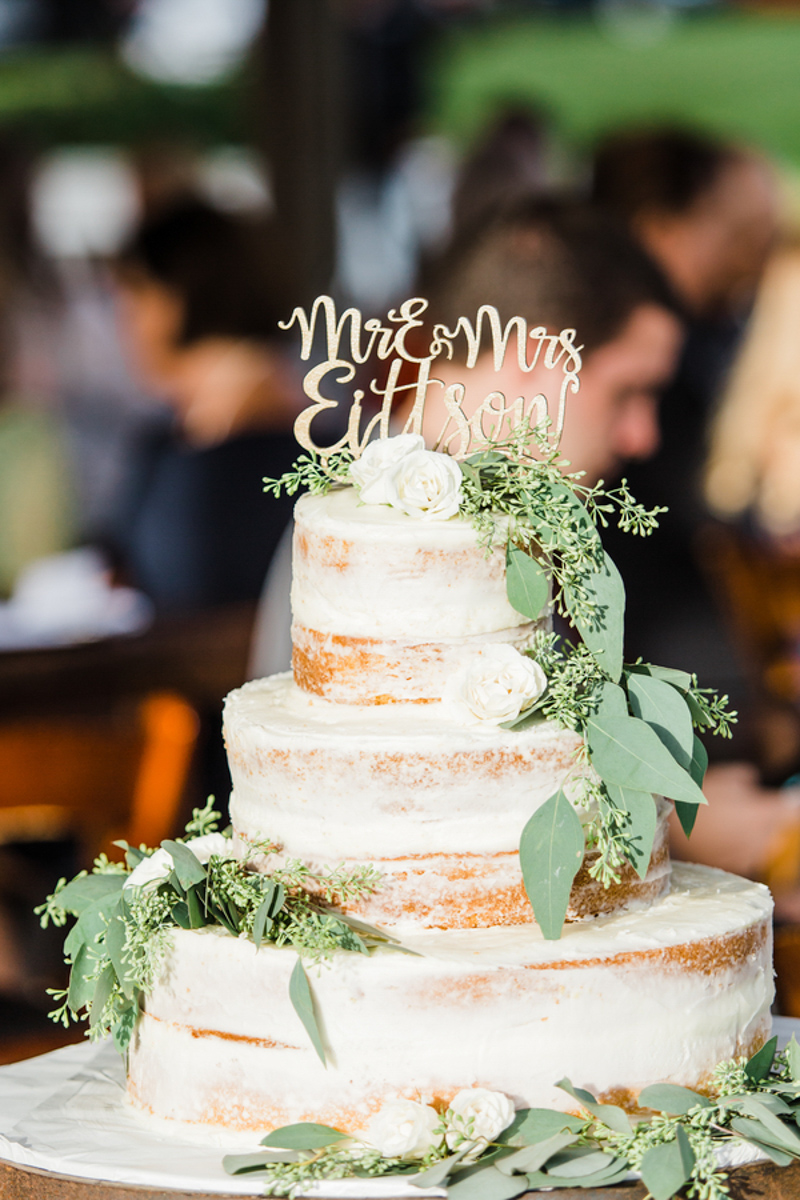 semi-naked wedding cake with greenery