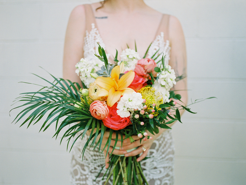 bride holding tropical wedding bouquet by Fern and Curl Designs