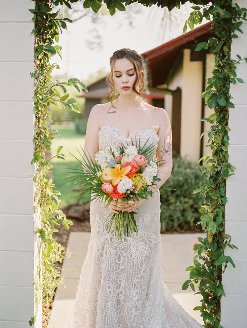 bride looking down at tropical wedding bouquet