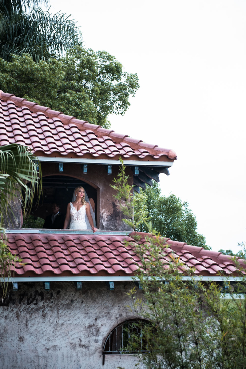 bride looking off of Sydonie Mansion balcony