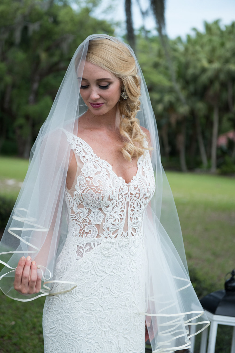 bride holding veil looking down