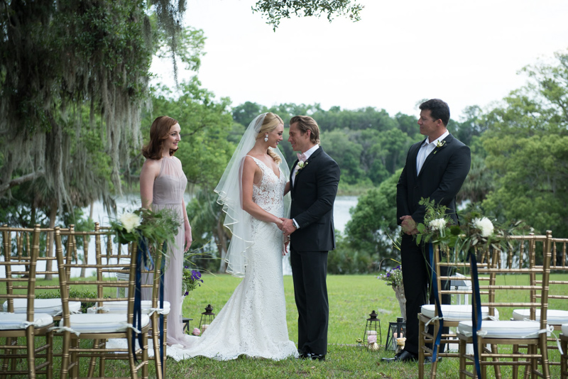 couple at lakeside wedding ceremony at the Sydonie Mansion