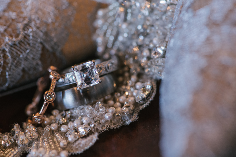 wedding bands laying on bridal veil