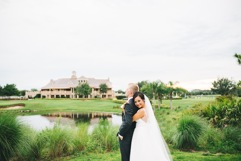 bride standing behind groom at Eagle Creek Golf Club