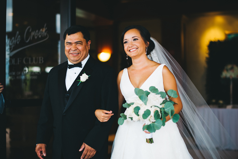 bride walking down aisle with father