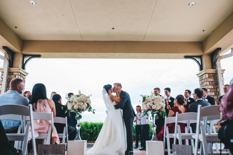 couple kissing for wedding ceremony