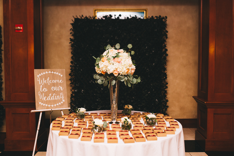 wedding guest favors on table with floral arrangement
