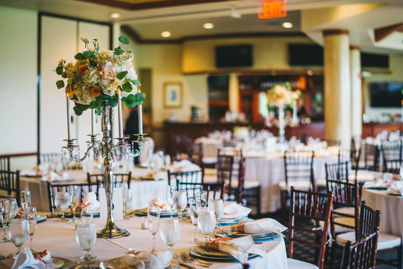 floral candelabra on white linen reception table