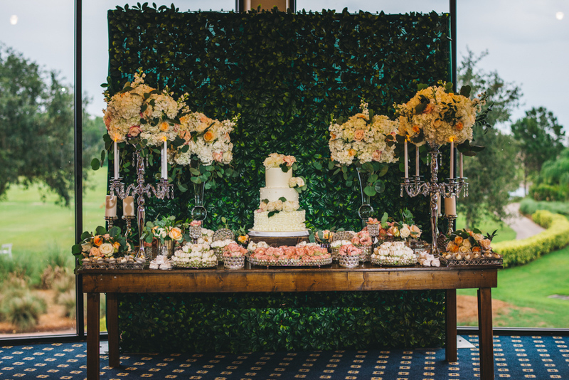 wedding dessert buffet with hedge wall backdrop
