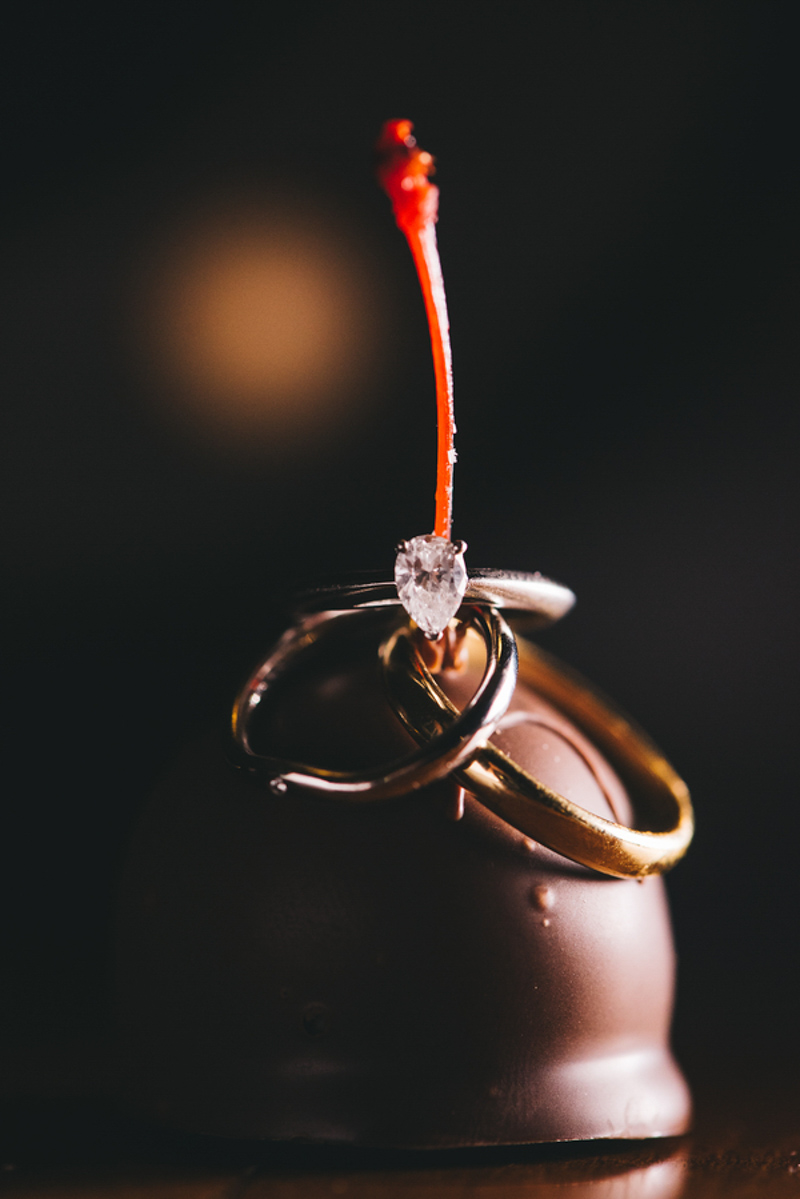wedding rings on chocolate covered cherry by Rudy and Marta Photography