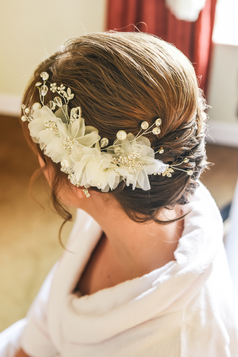bride with floral hairpiece on her updo