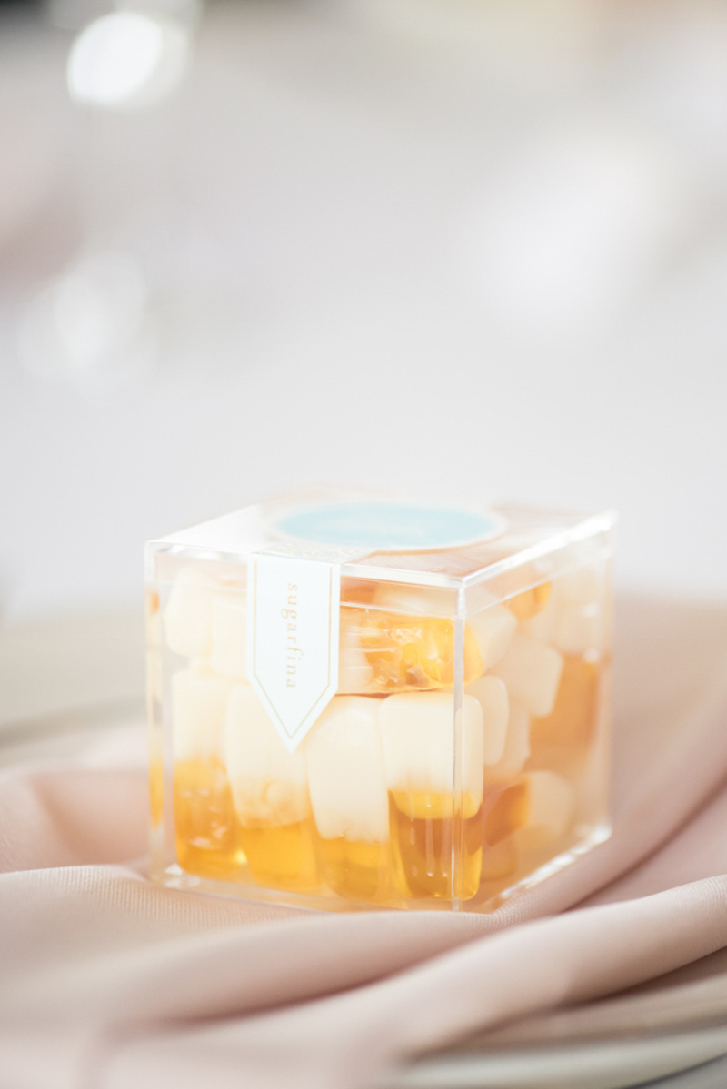Sugarfina gummies on dinner plates for wedding guest favors