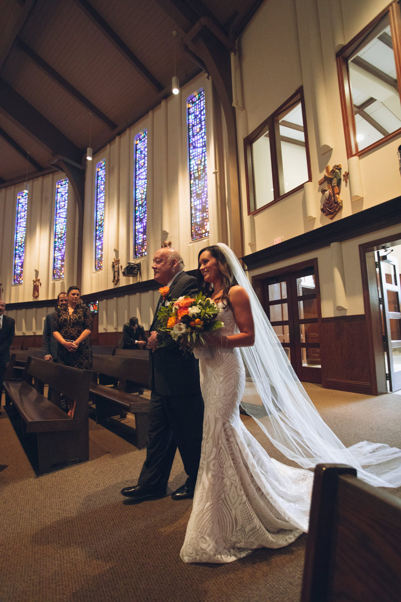 bride walking down the aisle at St. Margaret Mary's Catholic Church