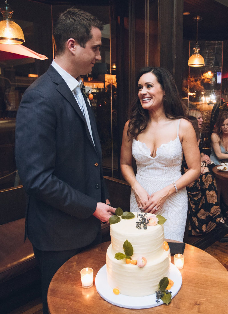 bride and groom cutting wedding cake