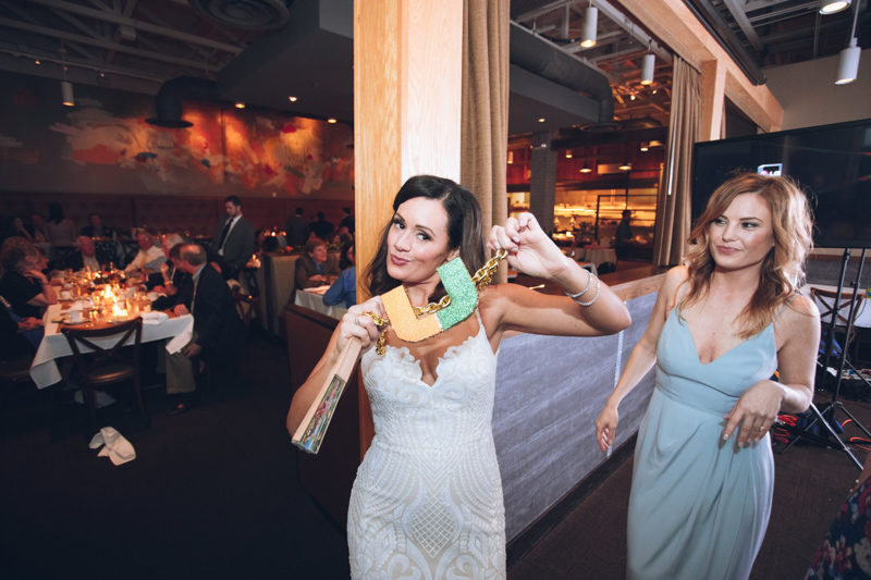 bride holding up University of Miami necklace