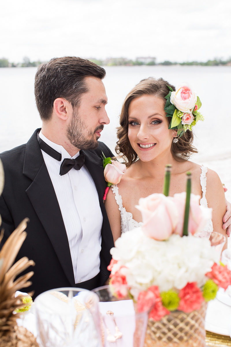 bride and groom sitting at table for Tropical Elegance at Paradise Cove shoot