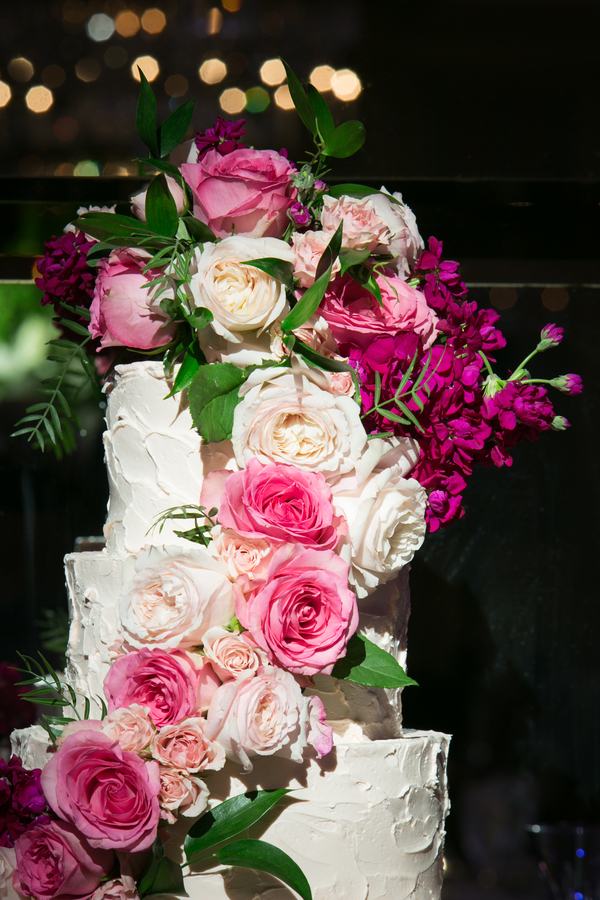 White buttercream wedding cake with pink flowers