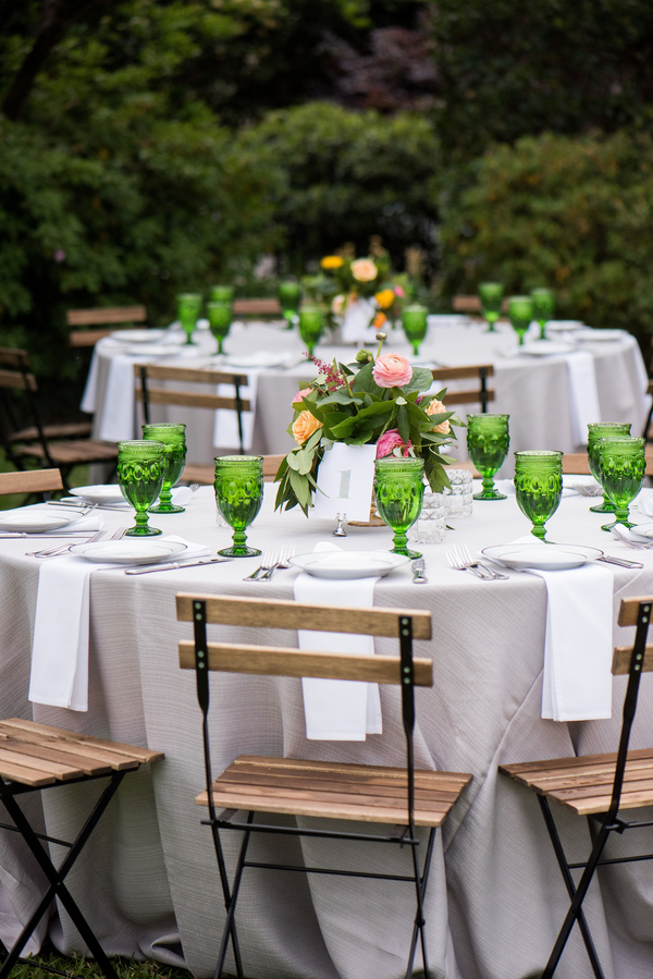 Wedding reception table with green goblet glasses