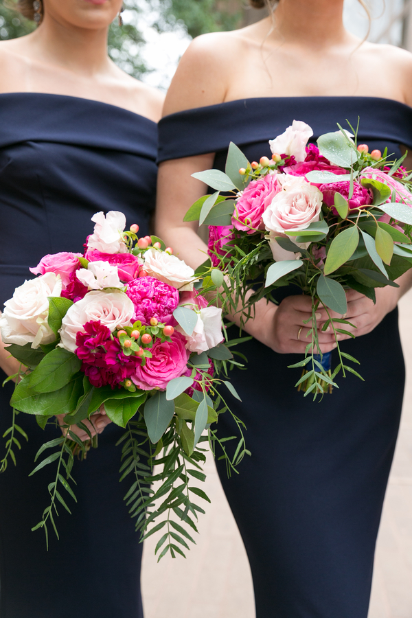 Pink bridal bouquets against blue bridesmaid dresses
