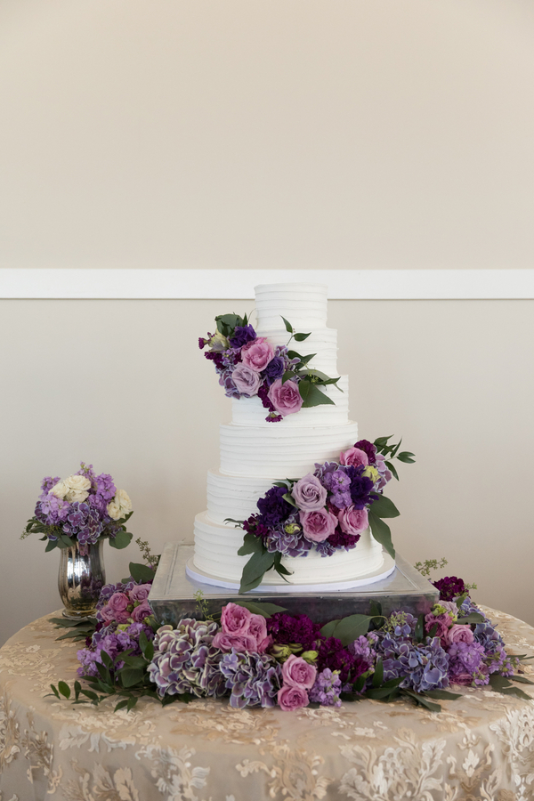 White wedding cake with purple flowers