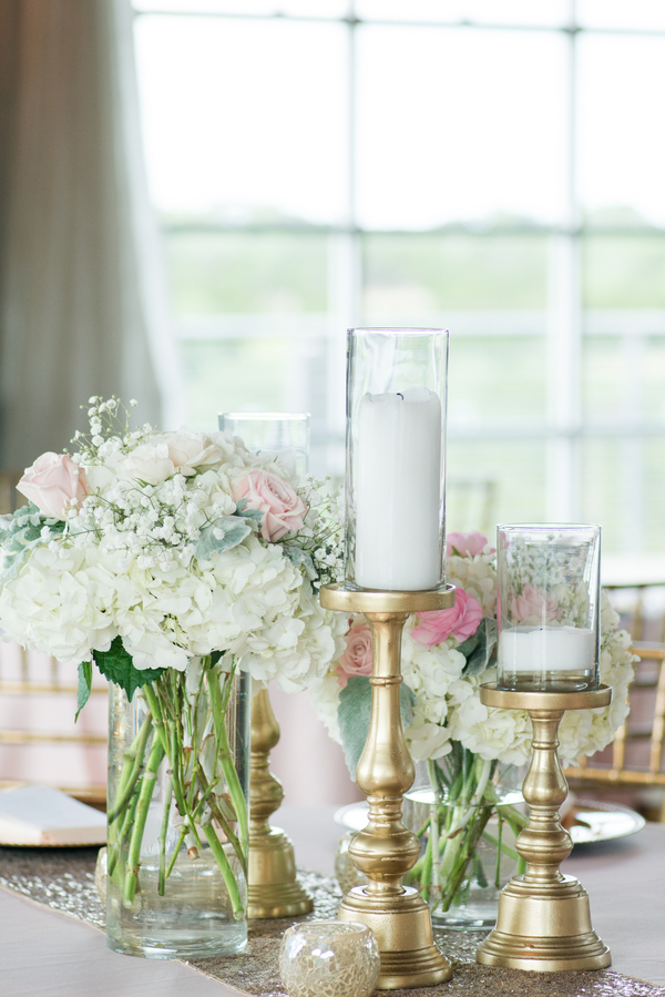 Cream and blush wedding centerpieces with pillar candles