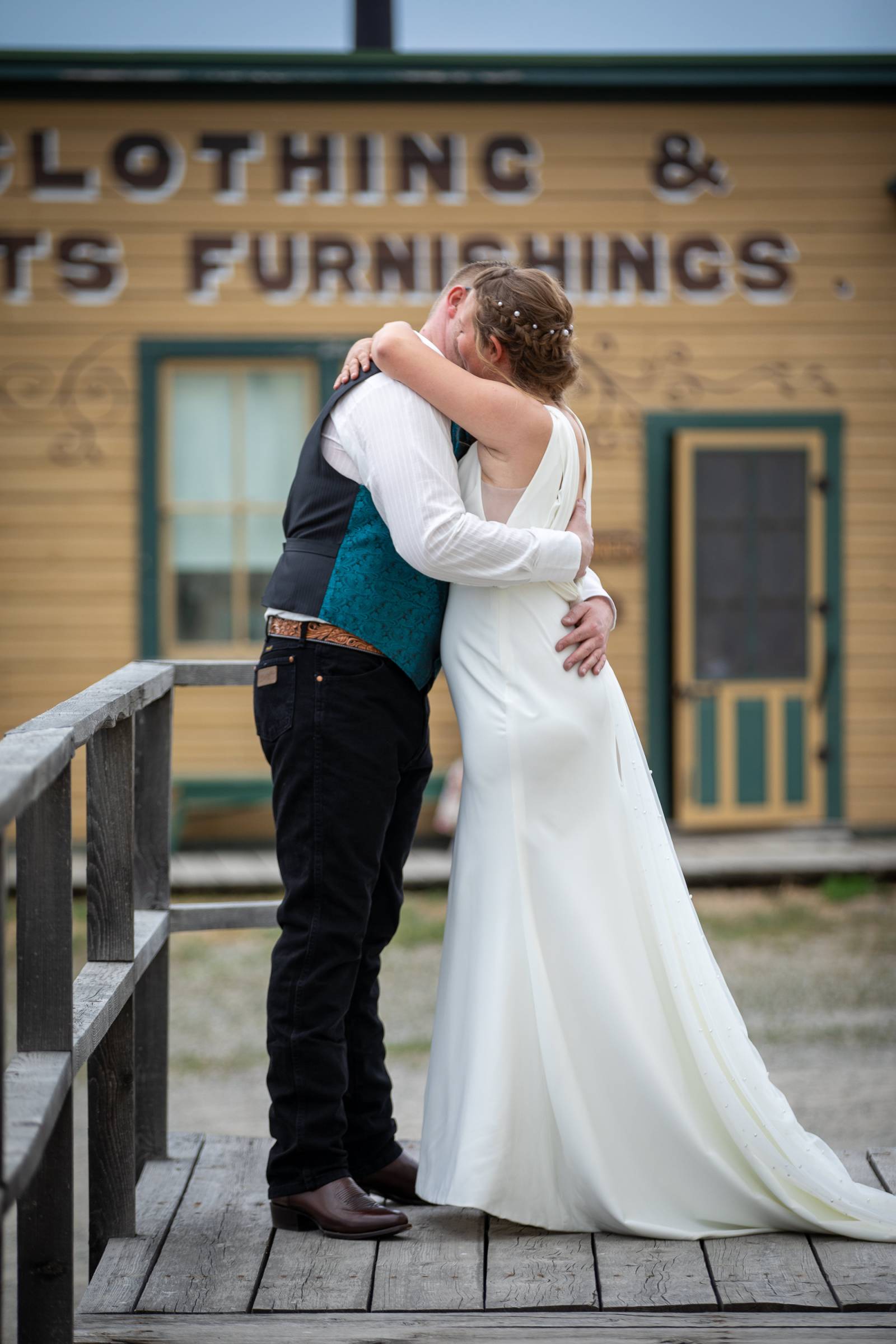 Bride and Groom kissing in front of vintage building at Fort Steele Heritage Town