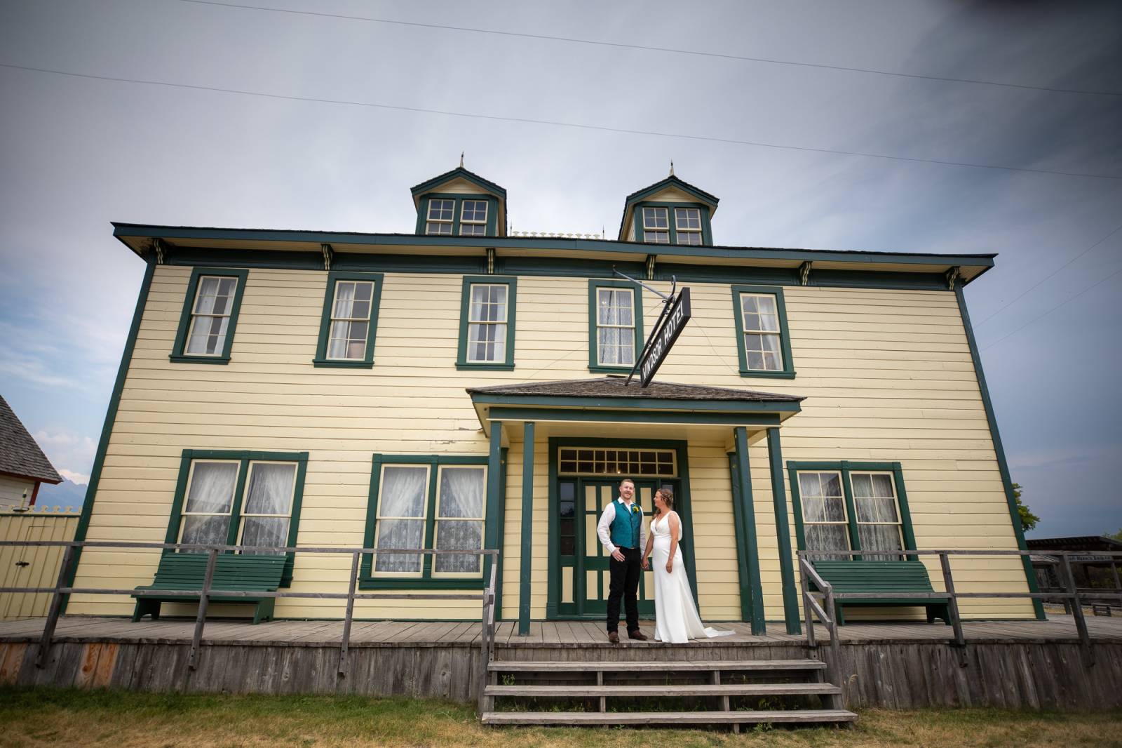Bride and Groom kissing in front of vintage hotel building at Fort Steele Heritage Town