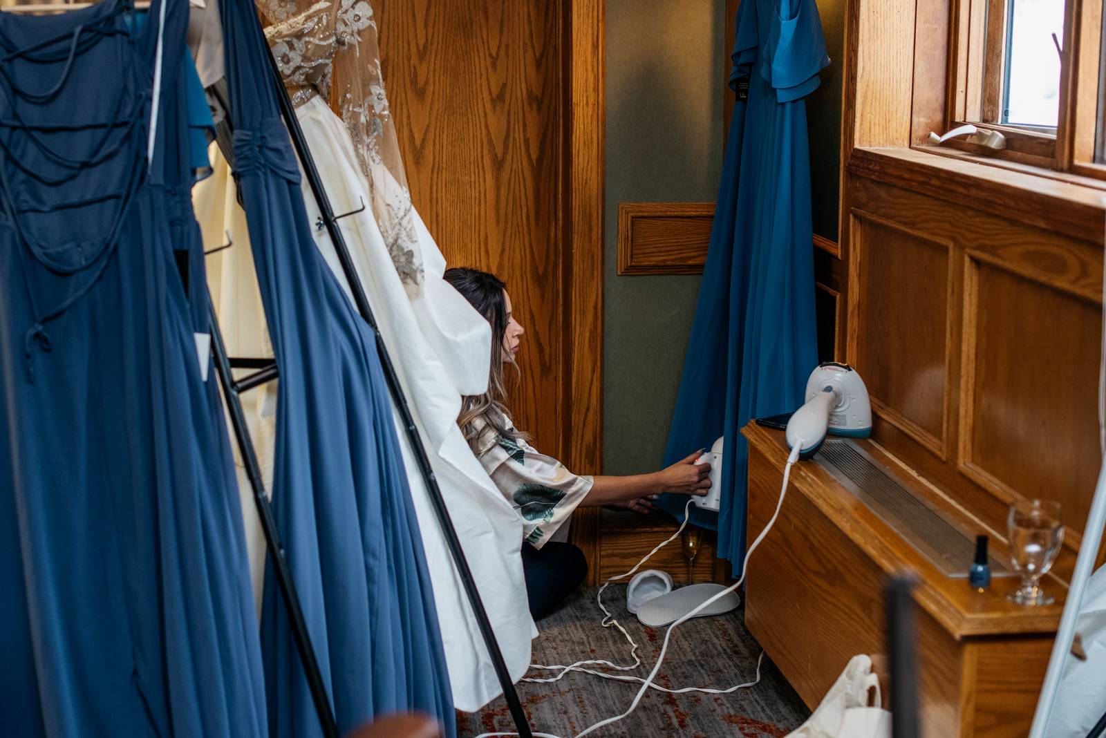 bridesmaid ironing her dress