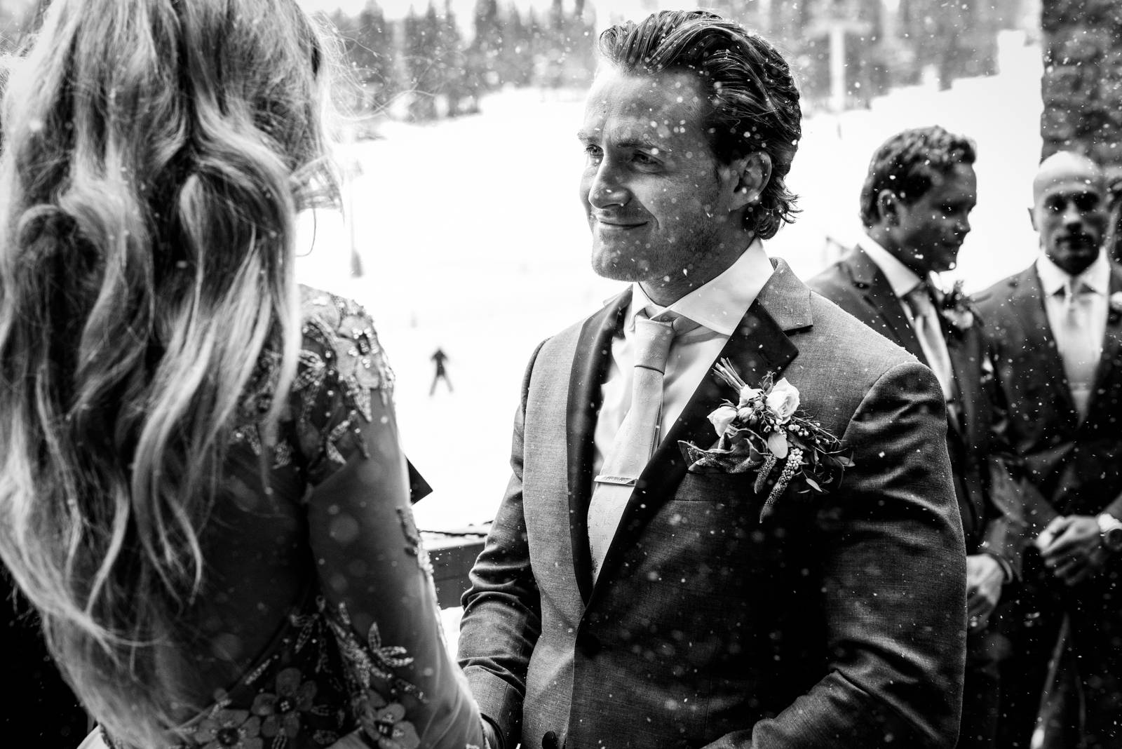 groom looking at the bride during the winter wedding ceremony