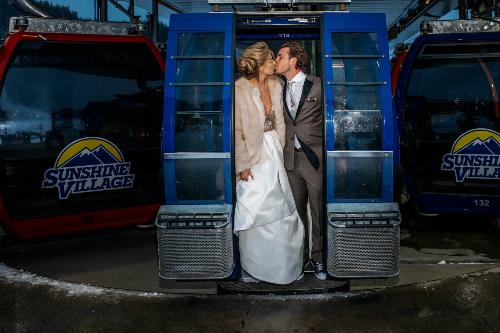 bride and groom kissing in the sunshine village gondola